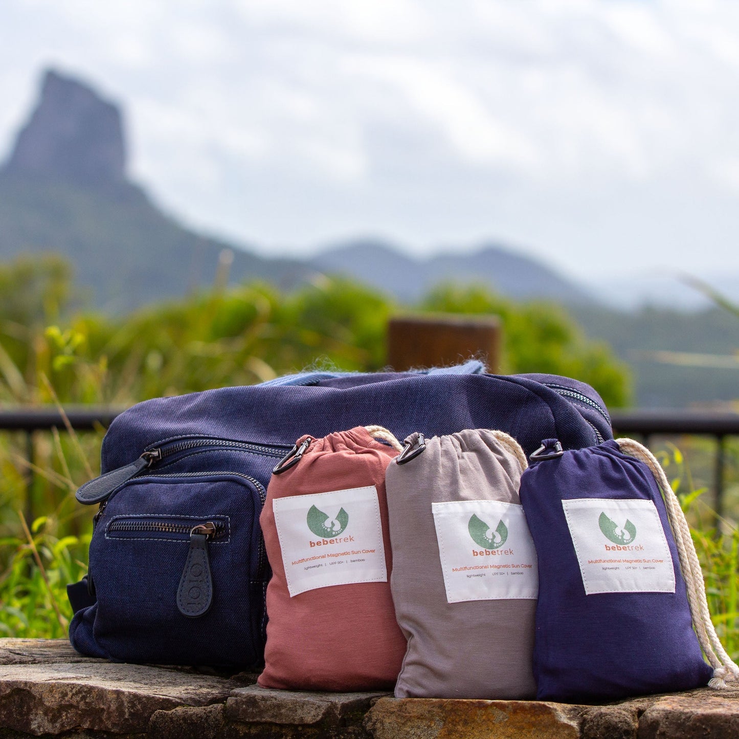 Multifunctional magnetic sun covers in their included bags by a nappy bag