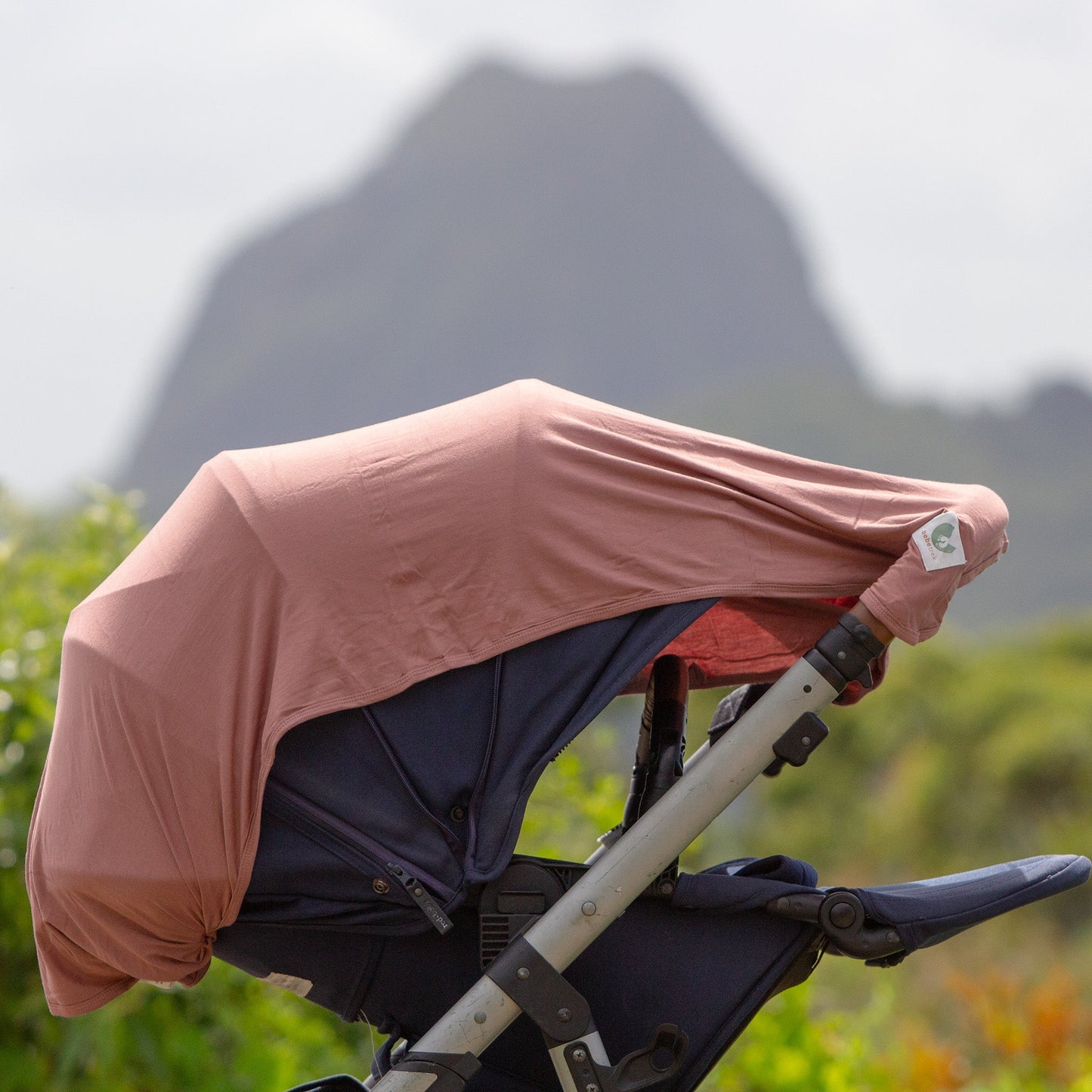 The Bebe Trek Multifunctional magnetic sun cover used as a pram shade cover.
