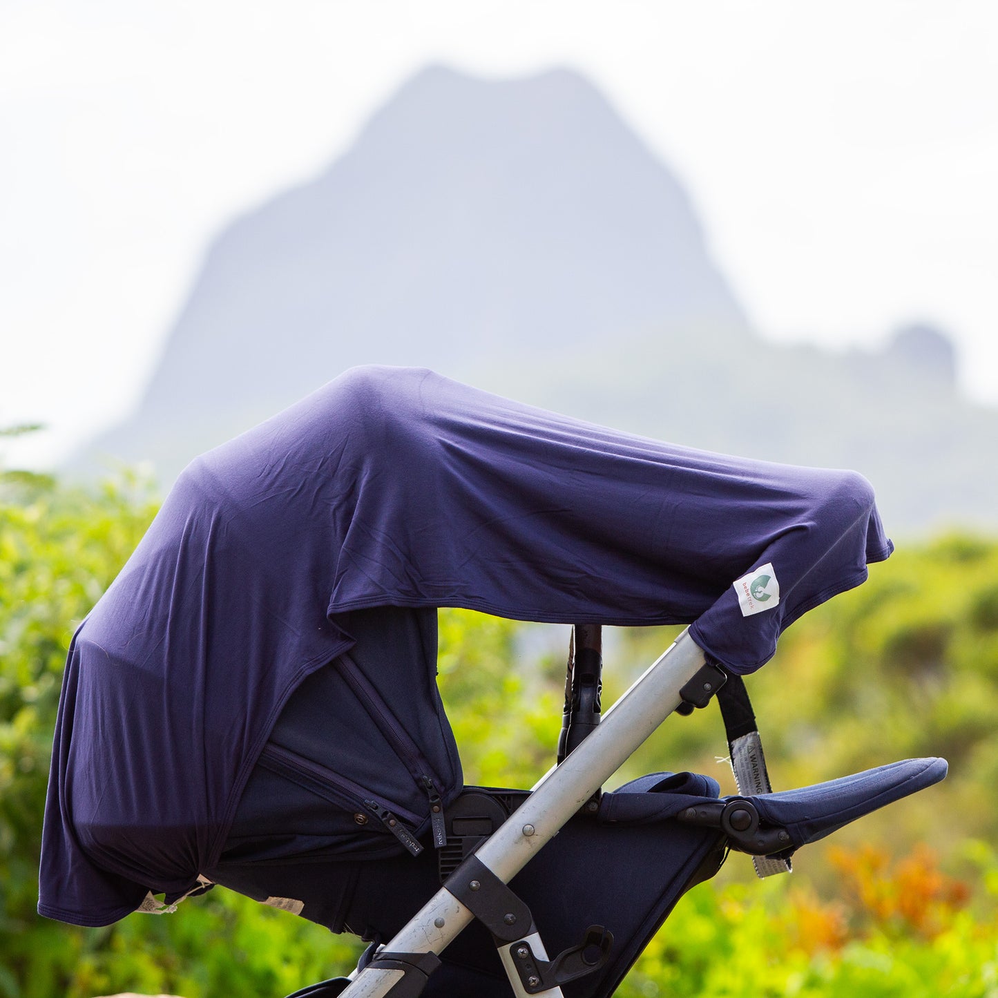 The Bebe Trek Multifunctional magnetic sun cover used a a pram shade cover in navy blue.